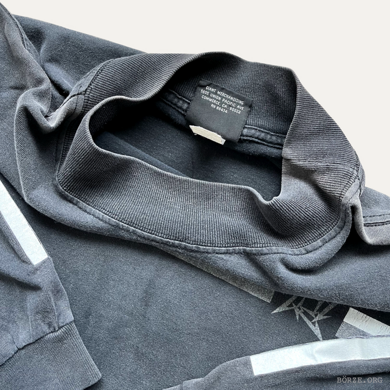 Gray shirt with a brand label on a light gray background